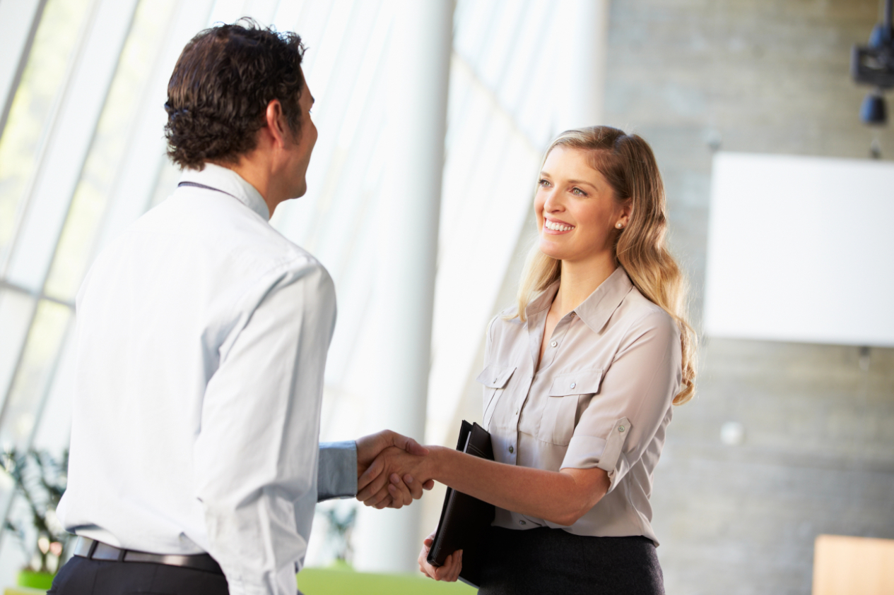 Businessman and businesswoman shaking hands